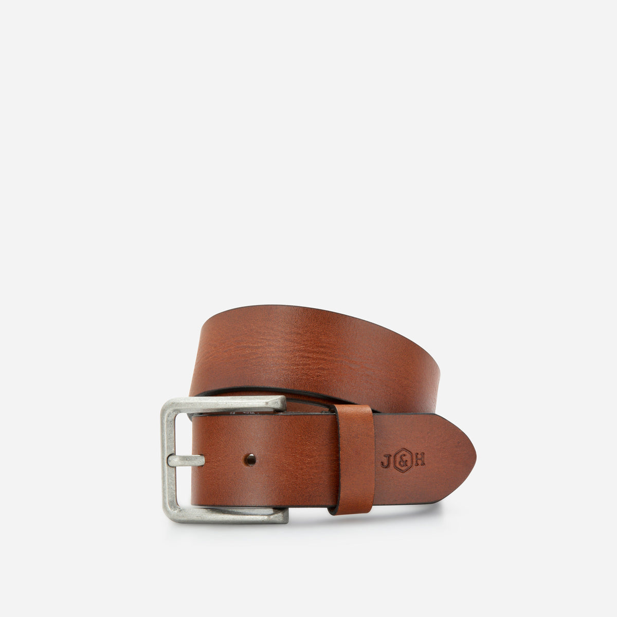 Tan leather Lyon belt rolled, showing the buckle and debossed logo, Jekyll & Hide