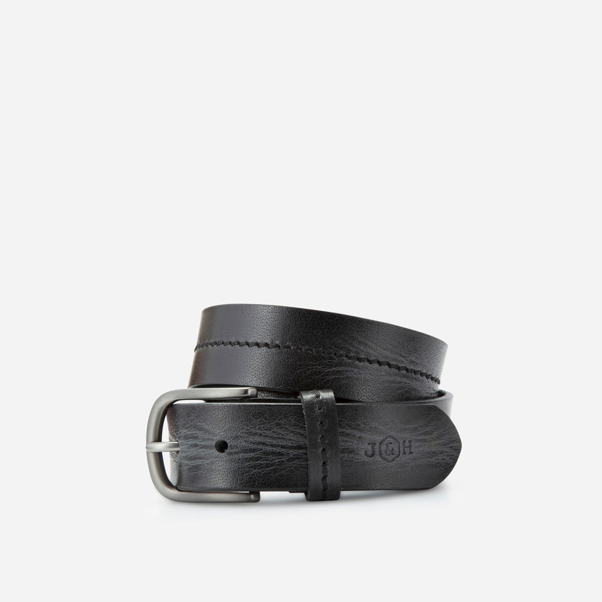 Black leather Bordeaux belt rolled, showing the stitched centre line and debossed logo, Jekyll & Hide