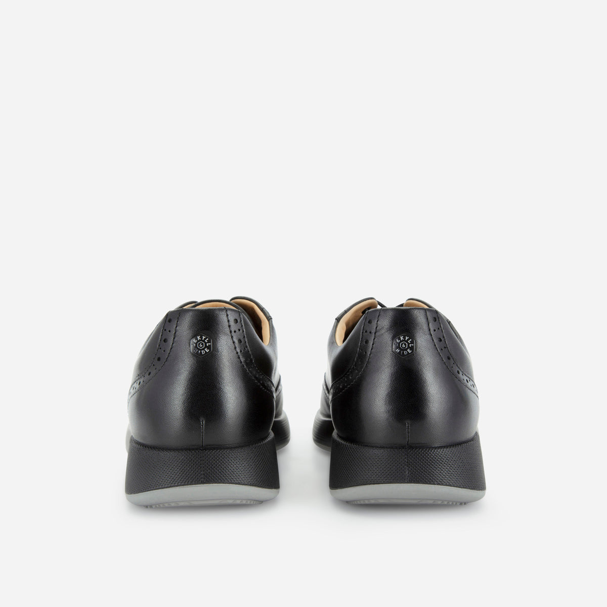 Black leather brogue sneakers, heel view with the Jekyll & Hide rivet