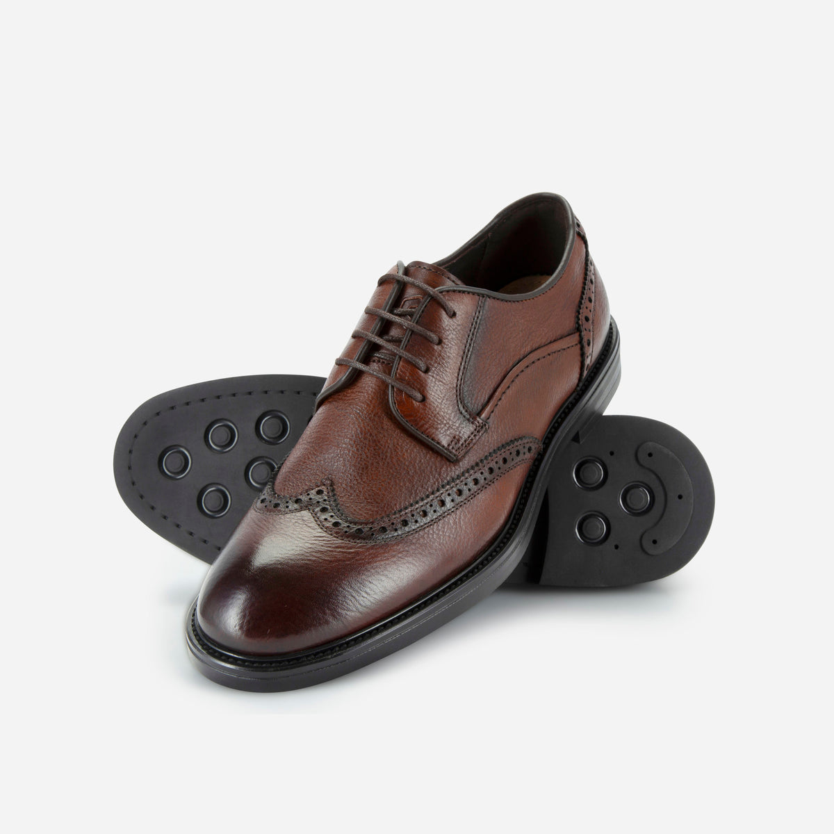 Brown leather brogue dress shoes showing the black rubber soles, Jekyll & Hide