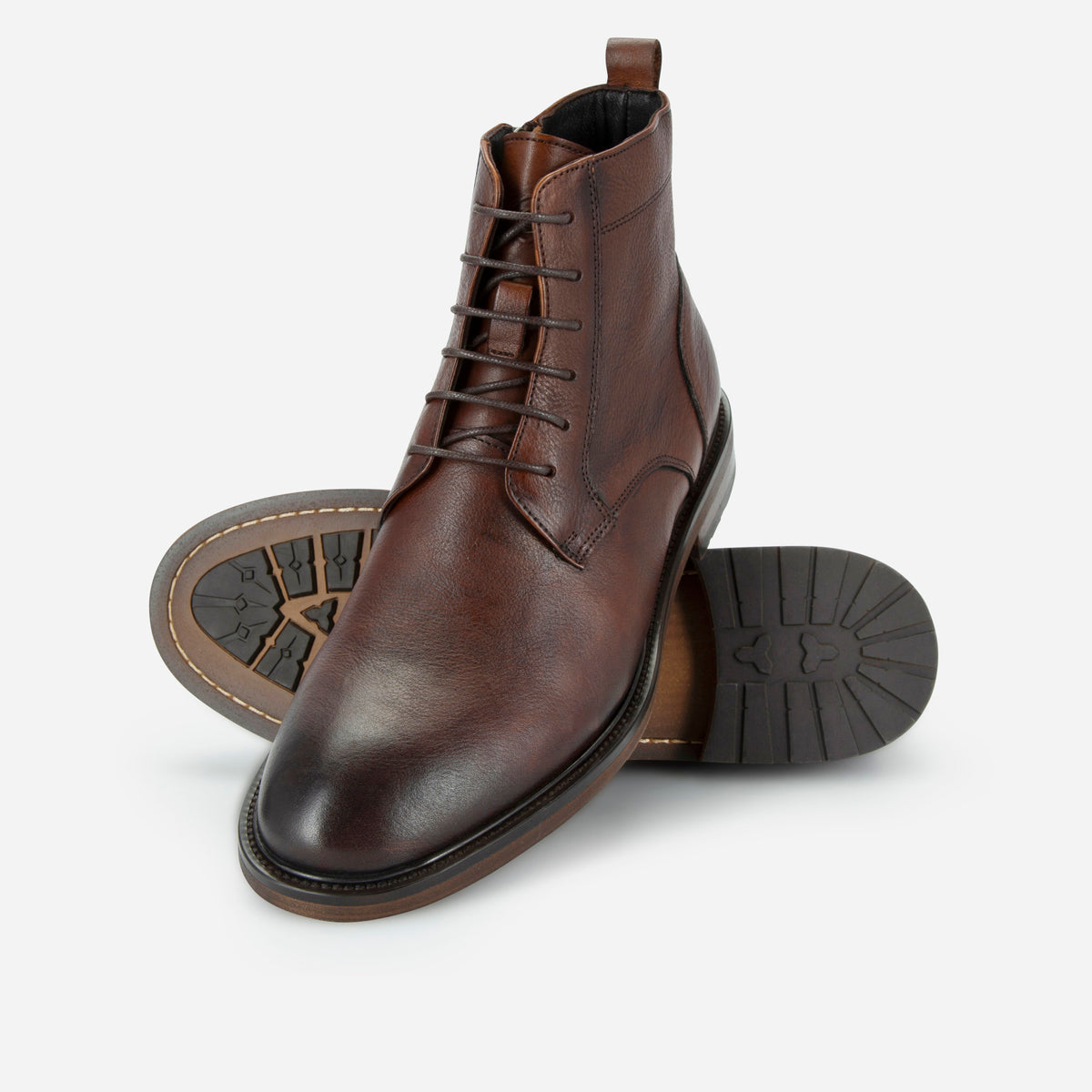 Brown leather lace-up ankle boots showing the black and brown rubber soles, Jekyll & Hide