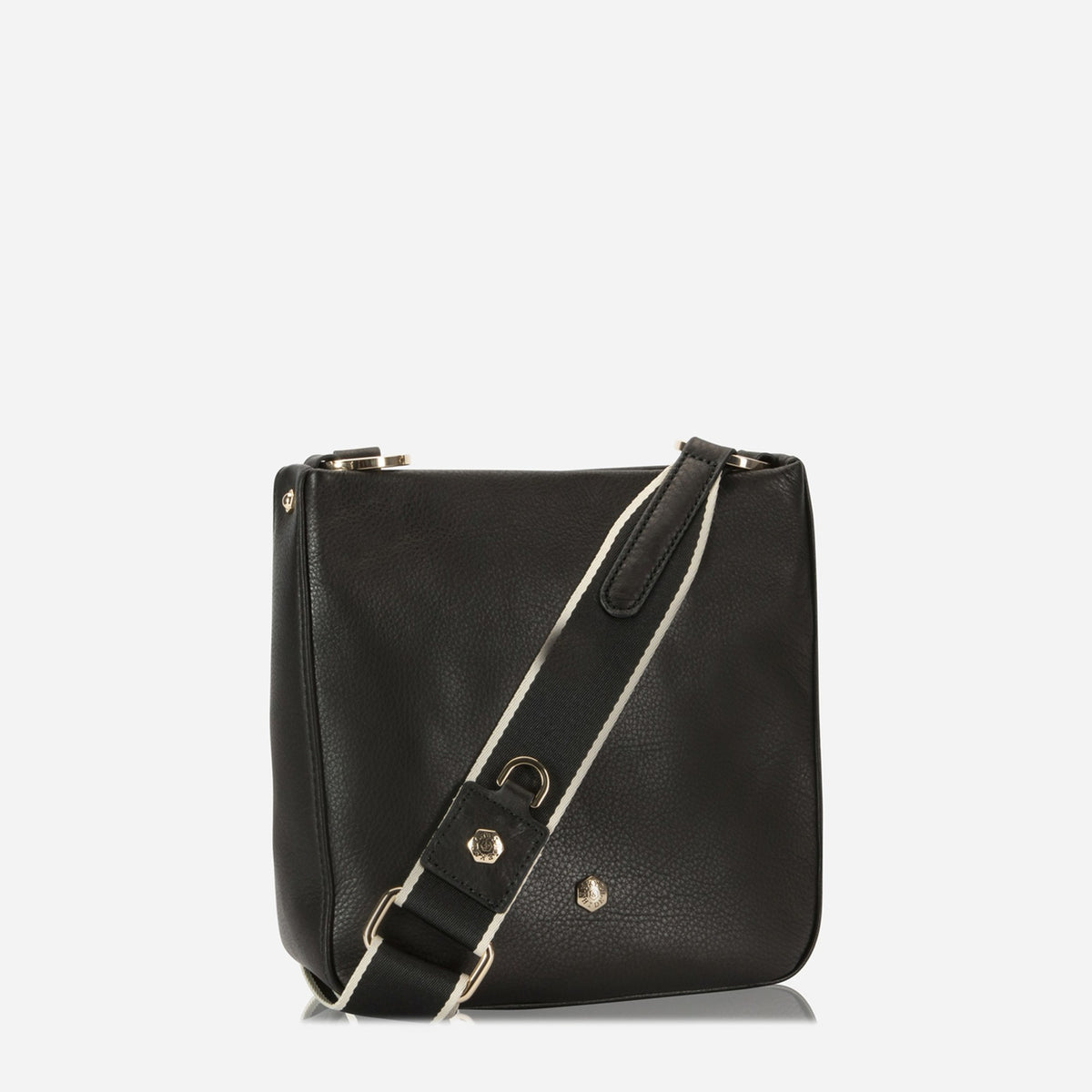 Three-quarter view of the Midnight Black leather Crossbody Bag with its webbing strap