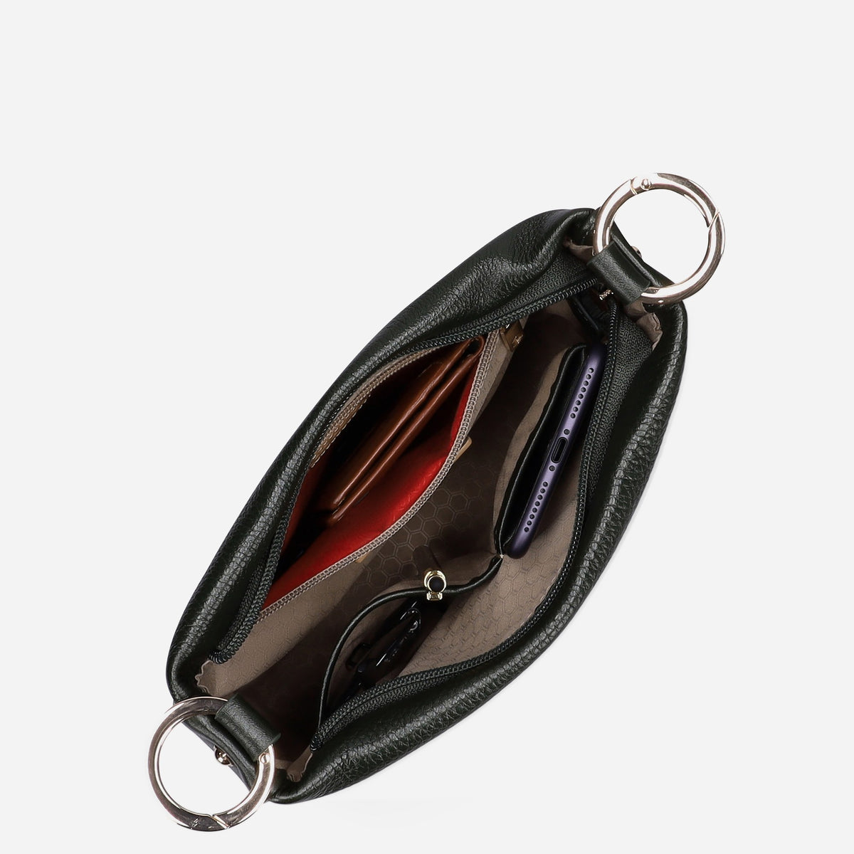 Crossbody Bag unzipped from above, showing essentials in the red-trimmed interior pockets