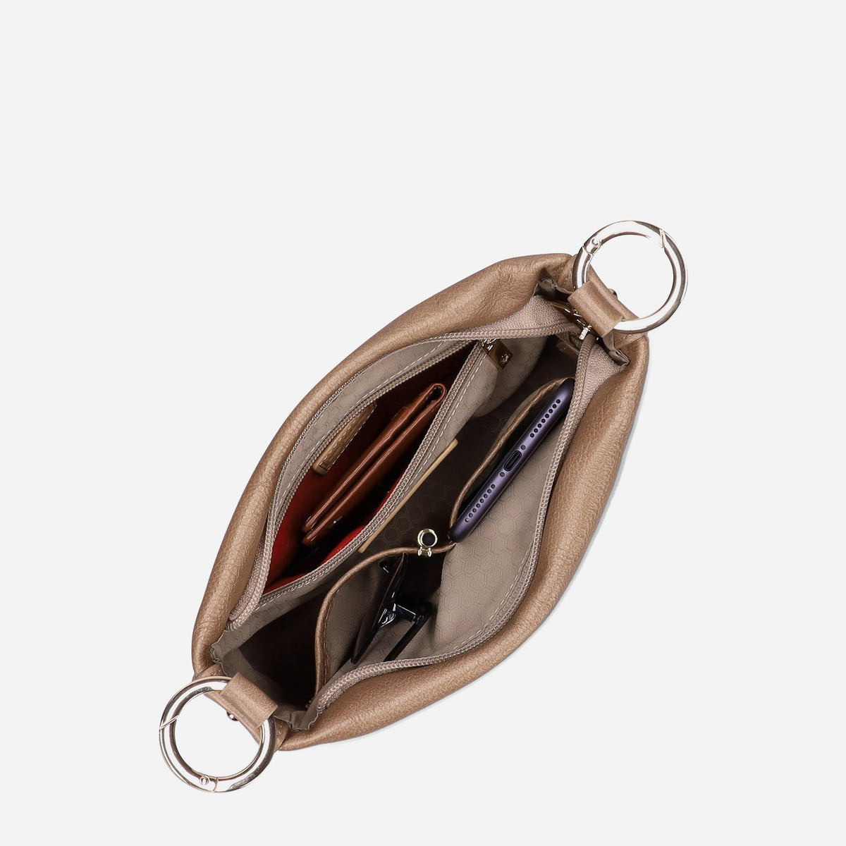 Oyster Crossbody Bag unzipped from above, showing essentials in the interior pockets