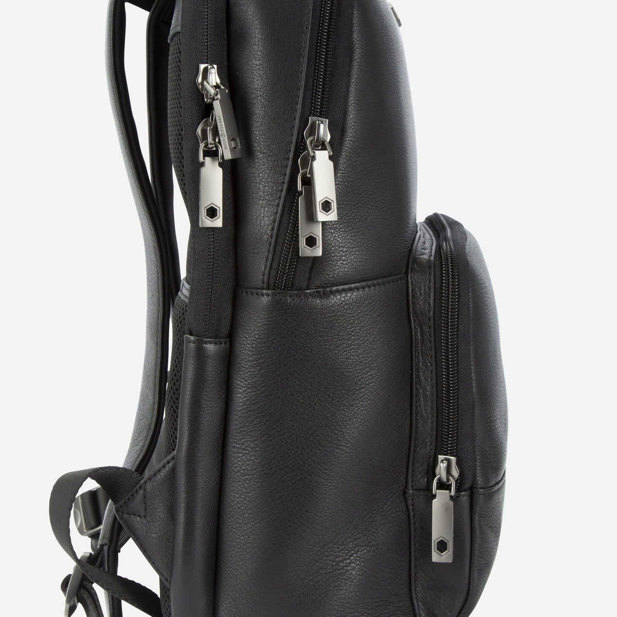 Side view of the black leather Cargo Backpack showing twin zips and side pocket
