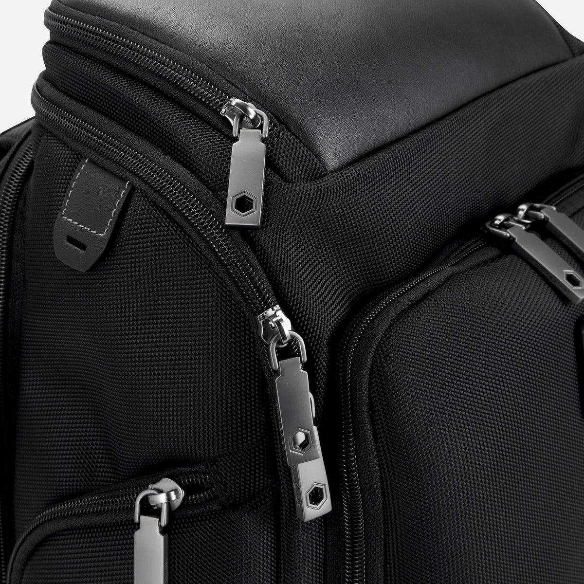 Close-up of the Tokyo Flip-Top Backpack's leather top panel and zip pulls