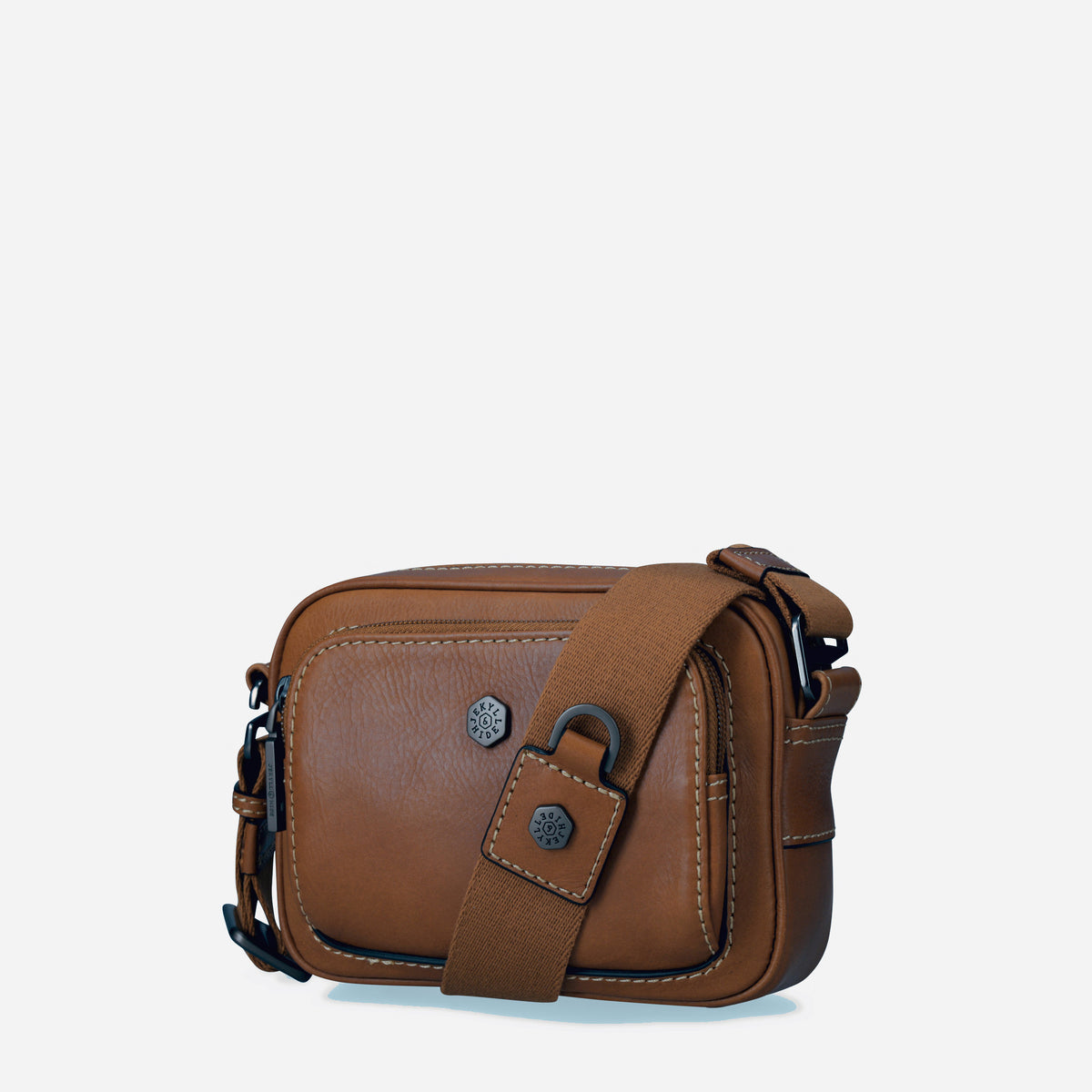 Three-quarter view of the Colt tan leather Crossbody Bag with adjustable strap
