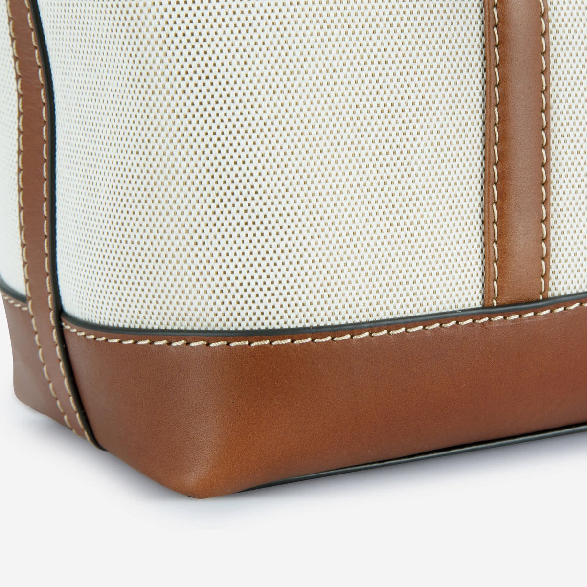Close-up of the Canvas Shopper Tote's textured canvas and stitched Colt leather base