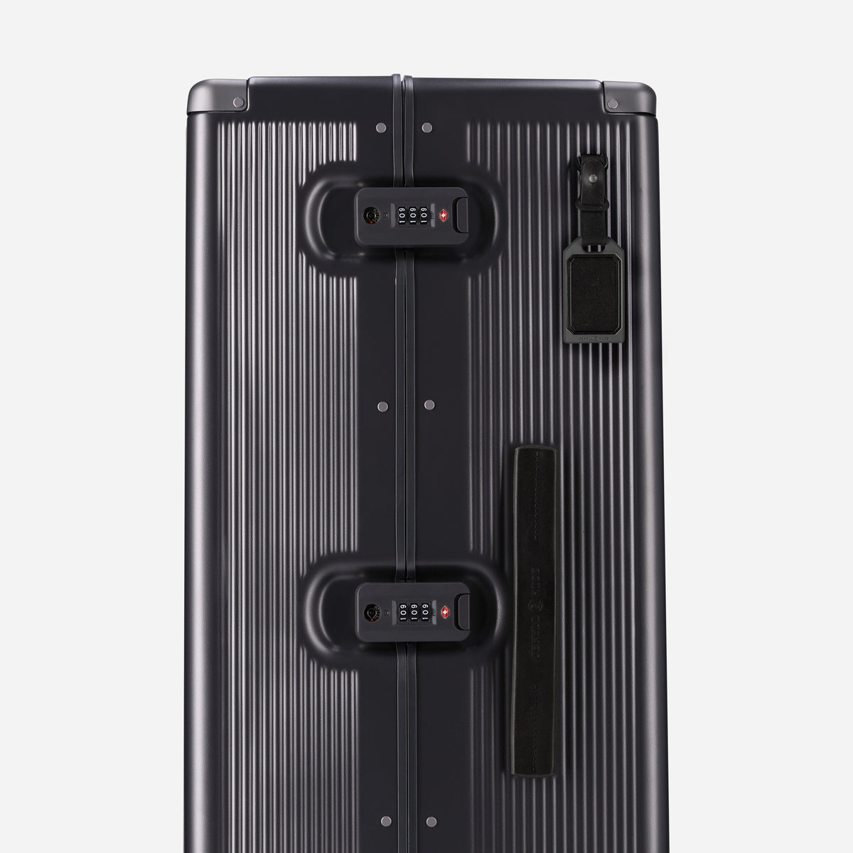 Side of the black-trim Large Check-In showing twin TSA locks, handle and luggage tag
