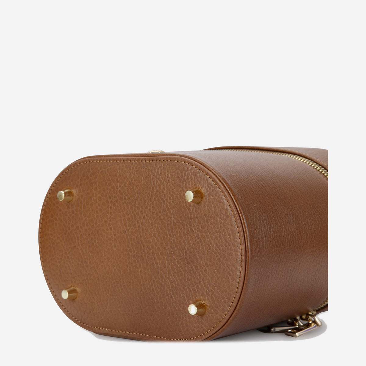 Base of the tan Geneva Vanity Case with gold-tone protective feet