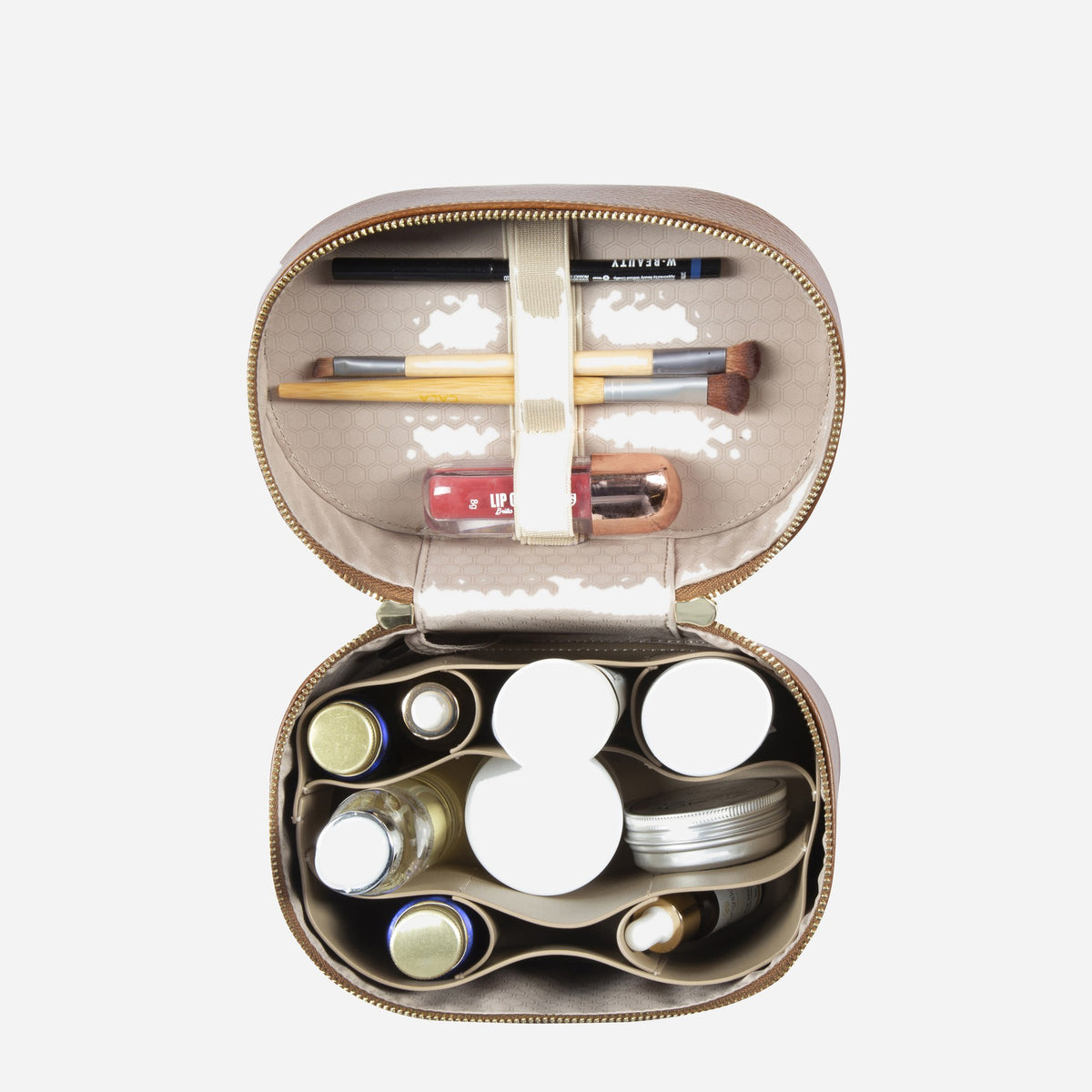 Tan Geneva Vanity Case open from above, filled with make-up and brushes